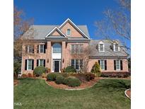 Charming two-story brick home with a manicured front lawn and mature landscaping at 3708 Wesley Ridge Dr, Apex, NC 27539