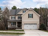 Charming two-story home with a two-car garage, inviting curb appeal, and a cozy front porch at 730 Toms Creek Rd, Cary, NC 27519