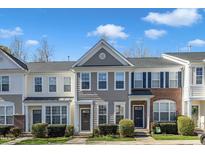 Charming townhome with well-maintained landscaping, neutral siding, and inviting front entrance at 8415 Reedy Ridge Ln, Raleigh, NC 27613
