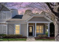 Charming single story home with a cozy front porch and meticulous landscaping at 11327 Shadow Elms Ln, Raleigh, NC 27614
