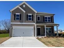 Charming two-story home with a welcoming front porch and a two-car garage at 120 W Victory View Ter # 51, Smithfield, NC 27577
