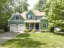 Charming two-story home featuring a well-manicured lawn, attached two-car garage, and a welcoming front porch at 1425 Princess Anne Rd, Cary, NC 27607