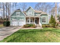 Charming two-story home with a manicured lawn, a two-car garage, and delightful curb appeal at 1425 Princess Anne Rd, Cary, NC 27607
