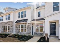 Charming townhome showcasing white siding, stone accents, and an inviting entrance at 1426 Cooper St, Sanford, NC 27330