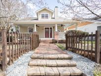 Charming home featuring a welcoming front porch with brick stairs and a beautifully landscaped front yard at 1426 N Roxboro St, Durham, NC 27701