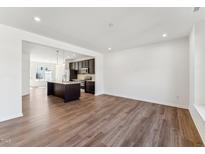 Spacious living room with modern hardwood flooring and an open layout leading to the kitchen at 1430 Cooper St, Sanford, NC 27330