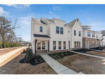Charming two-story home featuring a covered porch and beautifully landscaped front yard at 1432 Cooper St, Sanford, NC 27330