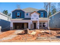 New two-story home with blue and gray siding and open garage under construction at 161 Klamath Dr, Garner, NC 27529