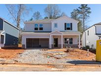 Charming two-story home with a two-car garage and a covered front porch, perfect for a growing Gathering at 169 Klamath Dr, Garner, NC 27529
