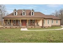 Inviting single-story home with a charming front porch and rocking chairs at 195 Falcon Ln, Rougemont, NC 27572