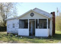 Exterior view of a house with a screened-in porch and white siding, showcasing its simple architectural design at 2984 Ashe Ave, Dunn, NC 28334