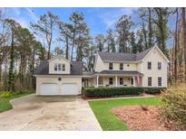 Charming two-story home with a welcoming front porch, manicured lawn, and an attached two-car garage at 3101 Rutledge Ct, Raleigh, NC 27613