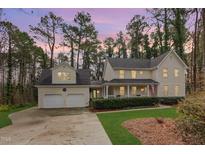 Charming home featuring a welcoming front porch, attached garage and lush landscaped front yard at 3101 Rutledge Ct, Raleigh, NC 27613