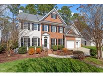 Traditional two-story home with brick and siding, landscaped yard, and attached two-car garage at 501 Nantucket Dr, Cary, NC 27513