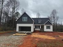 Two-story home with dark gray accent siding and an attached two-car garage on a cloudy day at 5344 Salem Woods Dr # 20, Graham, NC 27253