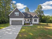 Charming home featuring a two-car garage and a mix of gray and white siding at 5344 Salem Woods Dr # 20, Graham, NC 27253