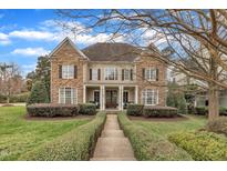 Charming two-story home featuring stone and siding accents, manicured landscaping, and a welcoming front porch at 601 Ballad Creek Ct, Cary, NC 27519