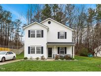 Charming two-story home with white siding, black shutters, and a well-maintained front lawn at 6923 Fox Haven Pl, Raleigh, NC 27616