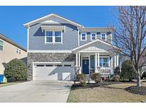 Beautiful two-story home featuring a charming front porch and a two-car garage at 745 Birch Arbor Cir, Raleigh, NC 27604