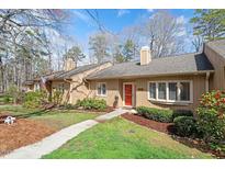 Charming home with tan siding, manicured lawn, and walkway leading to the front door at 7914 Yester Ct, Raleigh, NC 27615