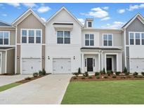 Charming townhome featuring a one-car garage, well-kept lawn, and modern architectural design at 96 Ripple Way # 316, Clayton, NC 27520