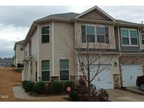 Beautiful townhome featuring traditional architecture, private driveway, and well-maintained landscaping at 1022 Azimuth Dr, Durham, NC 27713