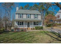 Charming two-story home featuring a welcoming front porch and well-maintained landscaping at 1104 Mango Crest Dr, Knightdale, NC 27545