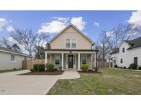 Charming two-story home with green siding, a covered porch, and a well-manicured lawn at 1105 Massey St, Smithfield, NC 27577