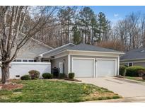 Charming home featuring an attached two-car garage and mature landscaping at 1331 Langdon Pl, Pittsboro, NC 27312