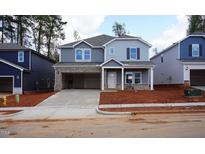 Charming two-story home featuring mixed siding and an attached two-car garage on a new construction lot at 157 Klamath Dr, Garner, NC 27529