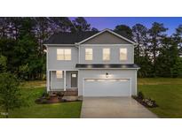 Charming two-story home with landscaped yard and an attached two-car garage at 20 Diamond Creek Dr, Zebulon, NC 27597