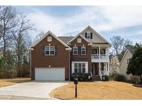 Charming two-story brick home with a manicured lawn and attached two-car garage at 2016 Terri Creek Dr, Fuquay Varina, NC 27526
