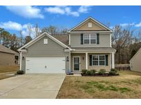 Charming two-story home with a two-car garage, manicured lawn, and inviting front porch at 2728 Spring Valley Dr, Creedmoor, NC 27522