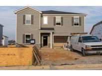 New two-story home featuring gray siding, an attached garage, and a welcoming front entrance at 3405 Rosebush Dr, Zebulon, NC 27597