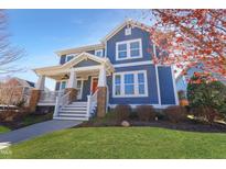 Charming two-story blue home with a welcoming front porch and well-manicured lawn at 375 N Serenity Hill Cir, Chapel Hill, NC 27516