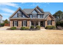 Charming two-story home featuring a combination of stone and blue siding under a roof at 4773 Swordfish Dr, Raleigh, NC 27603