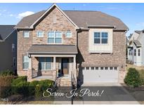 Beautiful two-story home with stone and brick accents, covered porch, and attached two-car garage at 504 Copper Beech Ln, Wake Forest, NC 27587