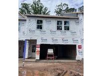 Unfinished townhouse shows the framing and structure, pre-drywall, with the garage visible at 6964 Doddridge Ln # 13, Cary, NC 27519