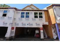 New construction townhomes featuring Tyvek HomeWrap, ready for finishing touches and personalization at 6966 Doddridge Ln # 12, Cary, NC 27519