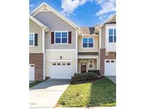 Charming townhouse featuring attached garages and well-maintained lawns at 7213 Terregles Dr, Raleigh, NC 27617