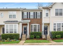 Charming townhomes featuring well-maintained lawns, brick facades, and updated exterior paint colors at 7753 Winners Edge St, Raleigh, NC 27617