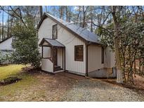 Charming exterior showcasing unique design, with lush greenery and gravel driveway at 864 Shadylawn Rd, Chapel Hill, NC 27514