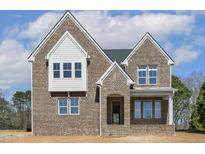 Newly built two-story brick home with gabled roofline and covered entryway at 9000 Penny Rd, Raleigh, NC 27606