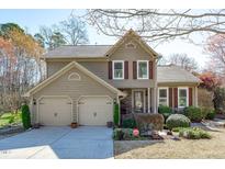 Charming two-story home features a two-car garage and well-manicured landscaping at 109 Covington Square Dr, Cary, NC 27513