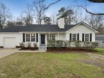 Charming single-story home with a well-manicured lawn and inviting curb appeal at 1213 Cotten Farm Dr, Fuquay Varina, NC 27526
