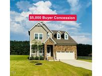 Charming two-story home with stone accents, landscaped yard, and a $5,000 buyer concession at 125 Scotland Dr, Youngsville, NC 27596
