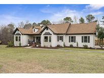 Charming brick home featuring a well-manicured lawn and classic architectural details for lovely curb appeal at 1512 Clark Farm Rd, Apex, NC 27502