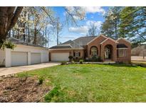 Inviting brick home with a manicured lawn and separate garage, offers classic charm and convenience at 199 Black Cloud Dr, Louisburg, NC 27549