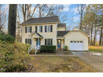 Charming two-story home features a classic design, attached garage, and a well-maintained front yard at 2009 Cypress Ct, Clayton, NC 27520
