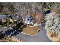 Charming two-story home with blue shutters, mature trees, and a well-manicured lawn on a corner lot at 2300 Parkside Dr, Durham, NC 27707